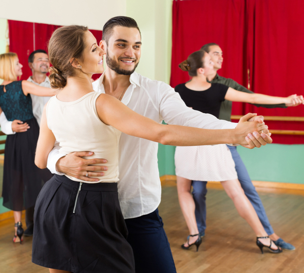 Group of Happy Young male and female dancing Ballroom